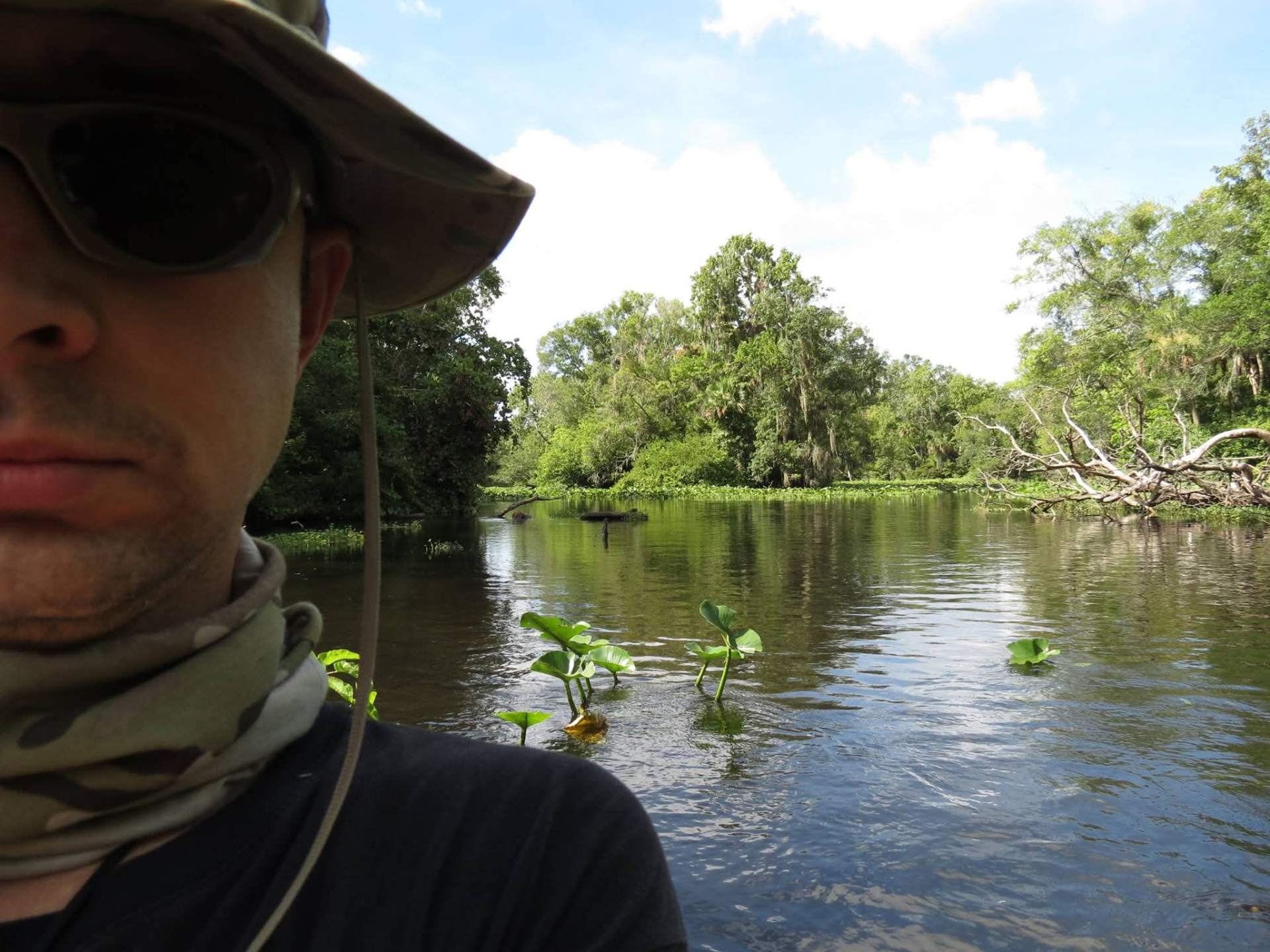 Doug Sahr on the water surrounded by lush greenery and water plants