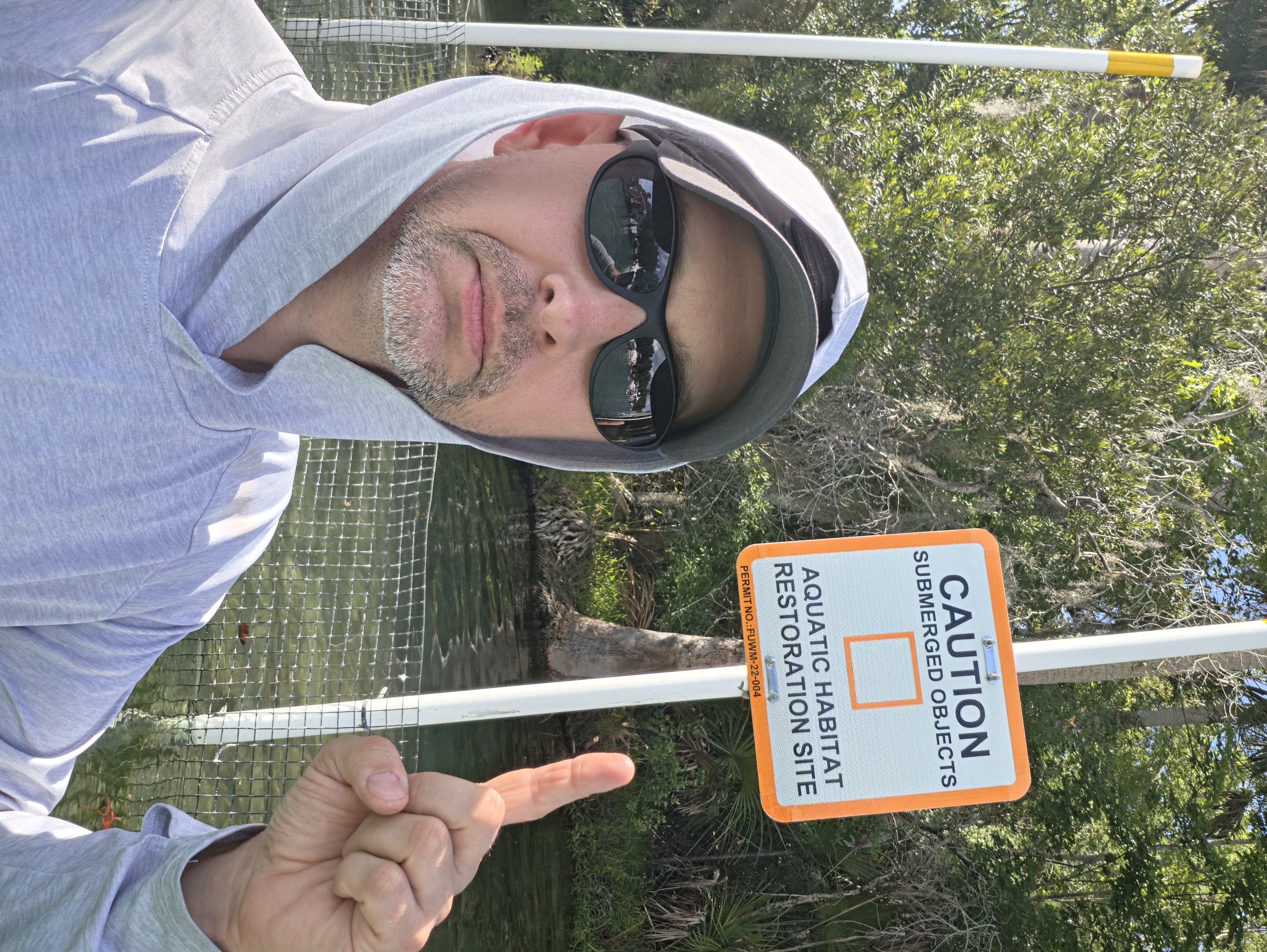 Doug Sahr at an Aquatic Habitat Restoration Site sign at a Florida spring