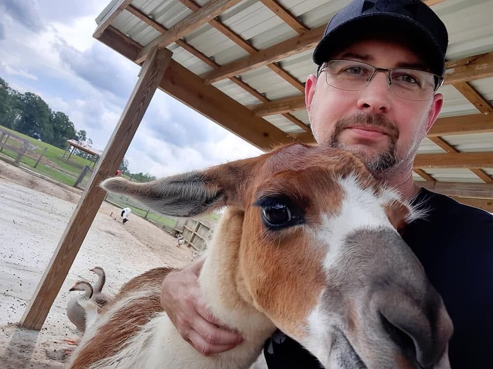 Doug Sahr with a llama at a West Orange barn
